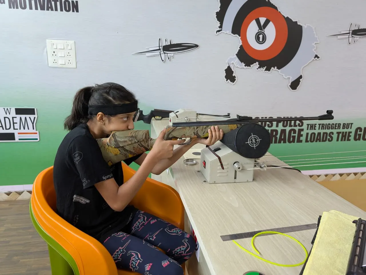 Young shooter taking aim with a 10m air rifle