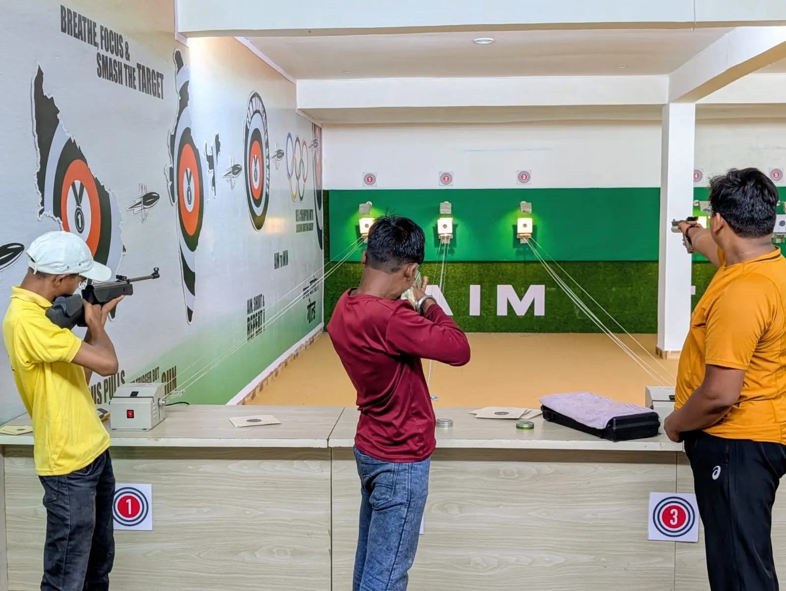 Students practising air rifle and air pistol side by side