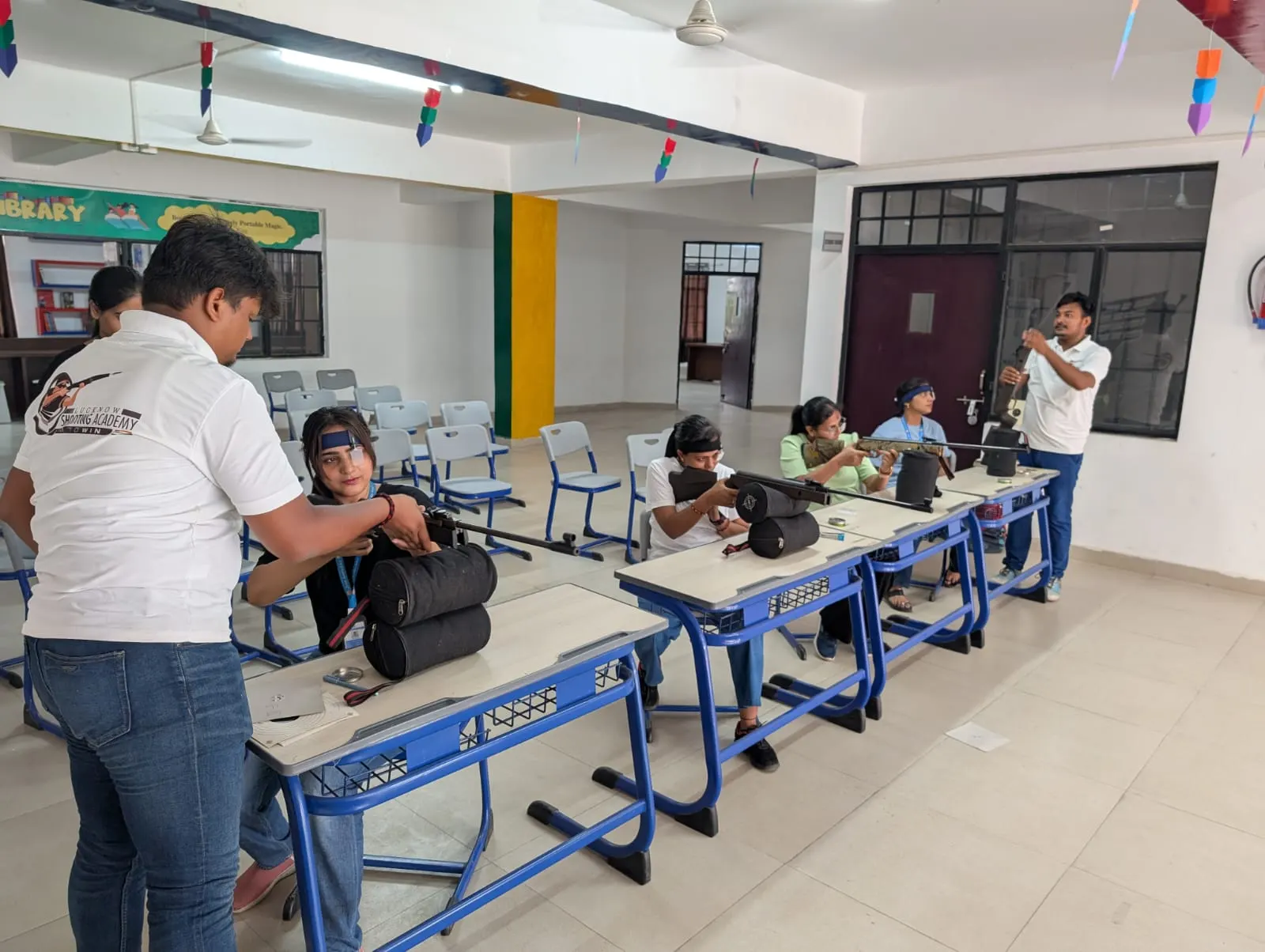 Coach adjusting a student's rifle position during training